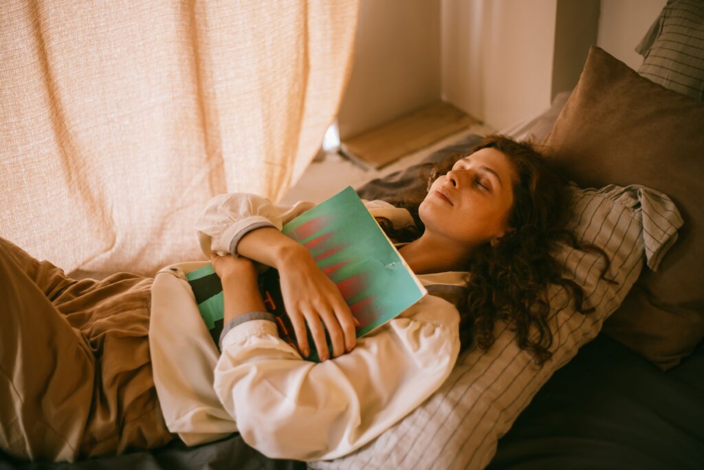Woman sitting peacefully near a window while releasing fearful thoughts